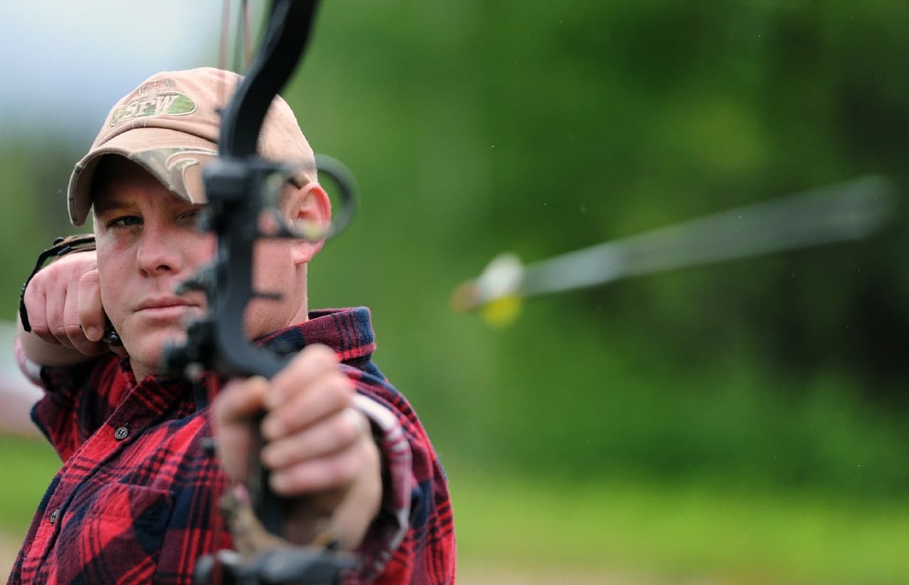 In this image a guy is playing archery metaphorically meaning that keep your health goals on target Top 10 health and fitness tips