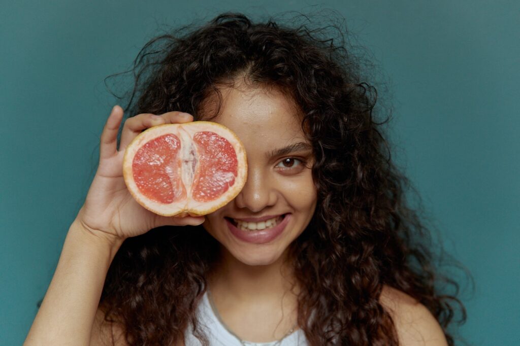 girl with a grapefruit smiling